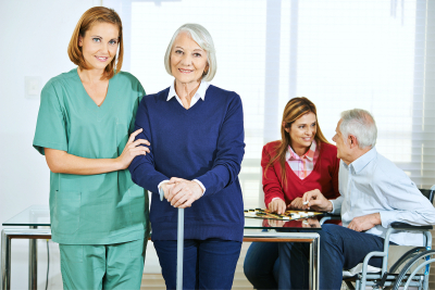 caregiver working with happy senior people
