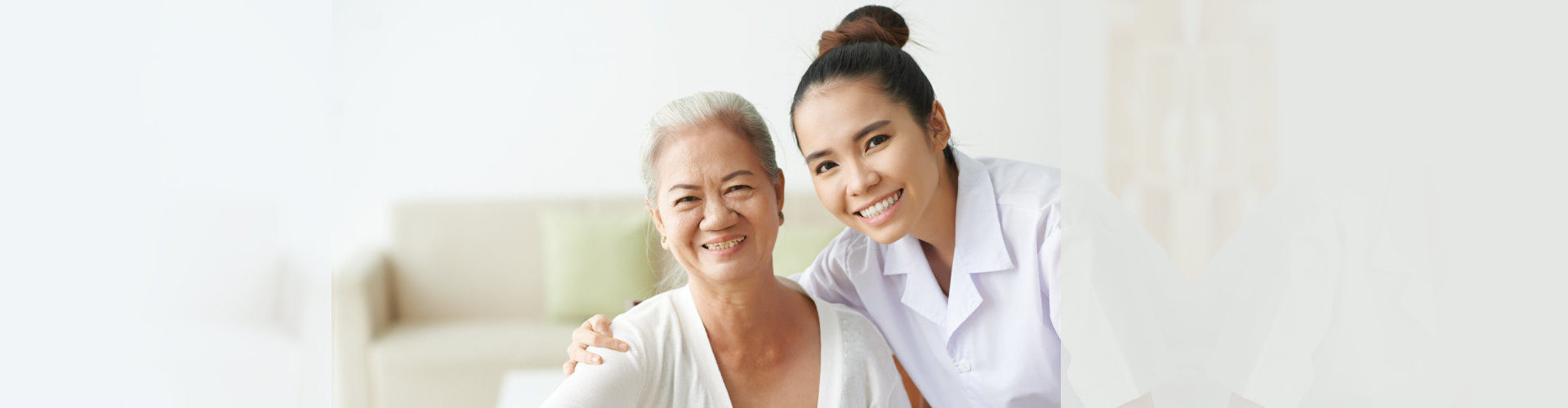 caregiver and senior woman smiling